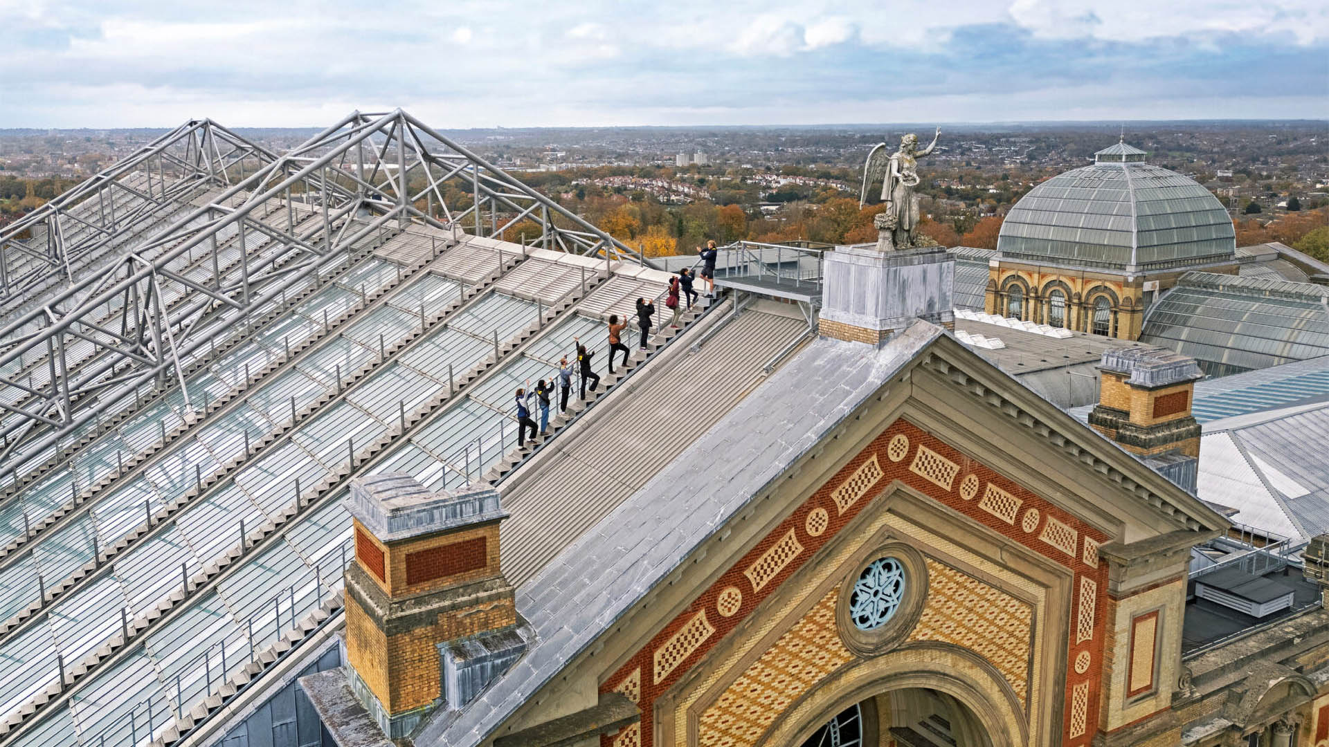 A photo of people climbing up the Alexandra Palace roof. 
