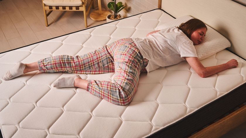 A person lies in a stomach sleeping position on the Extra Firm side of the Plank FIrm mattress