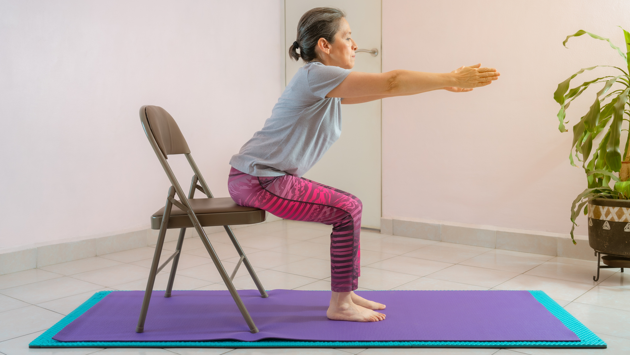 Woman performing sit-to-stand exercise