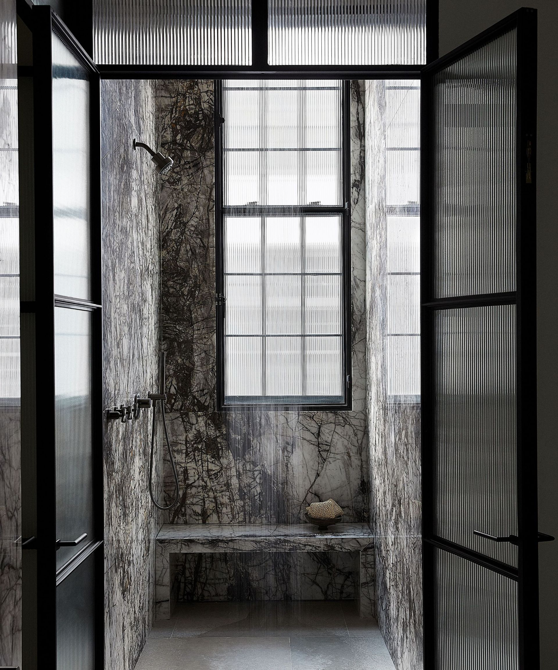 shower room with dark gray marble walls