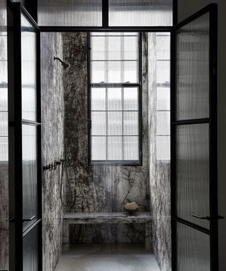 Shower room with dark gray marble walls