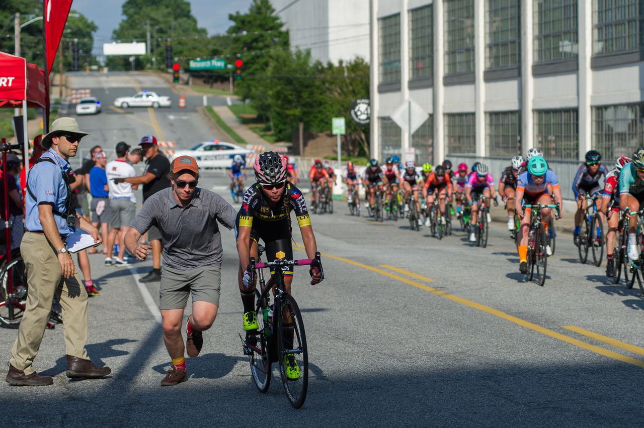 A rider gets pushed back into the race after a mechanical.