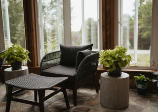 Outdoor furniture black sitting chair in a stone paved area