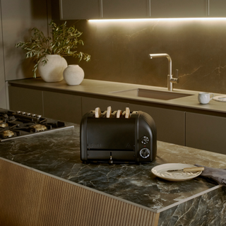 Stealth edition black toaster on a black marble kitchen countertop