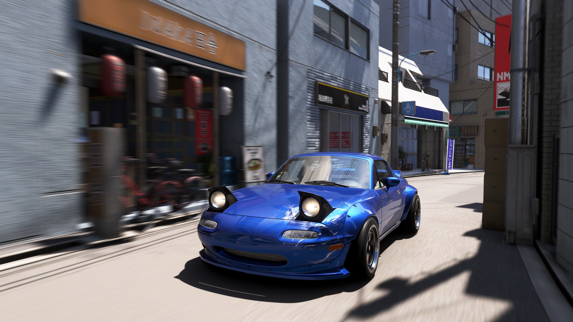 A blue car speeds through a Tokyo backstreet as shopfronts blur in the background in Forza Horizon 6