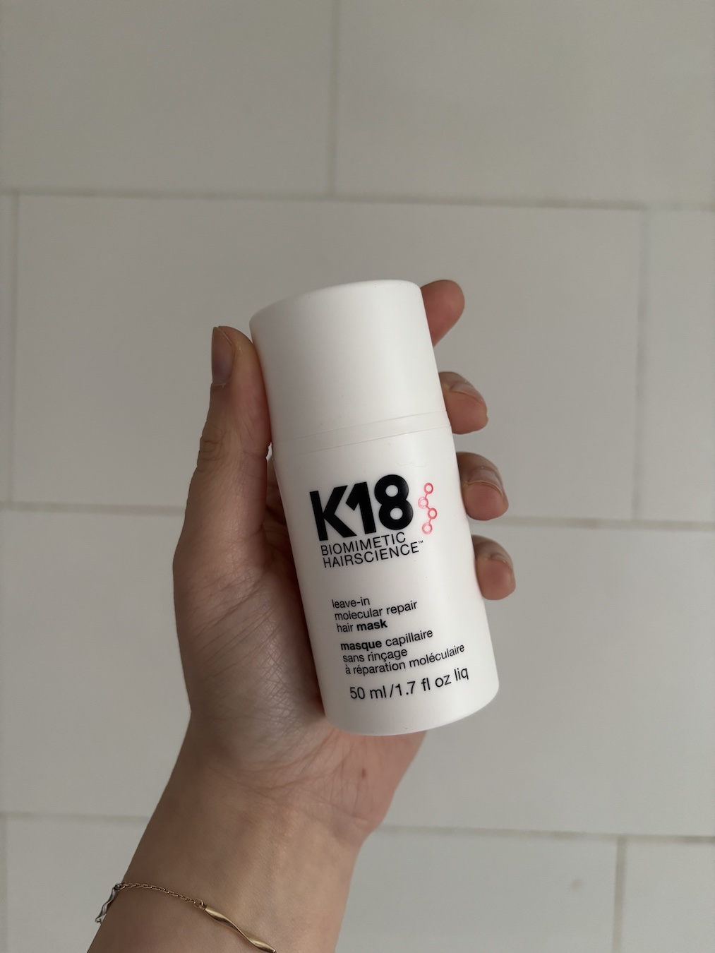 Mica Ricketts holding K18 Leave-In Molecular Repair Hair Mask