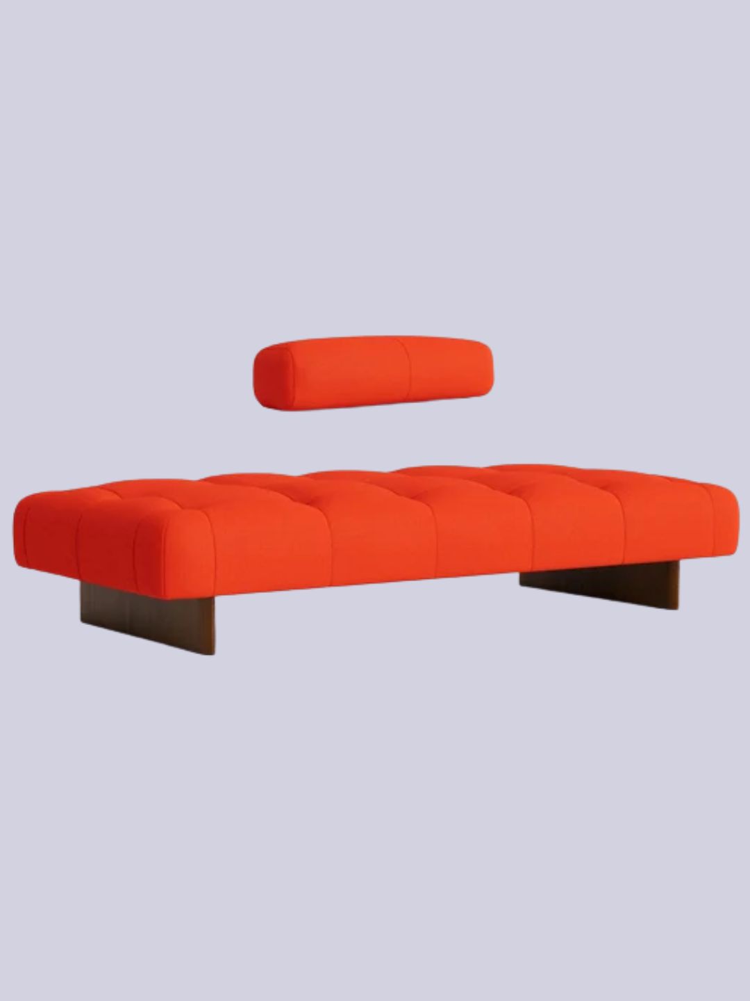 A bright orange daybed with a cushion from HAY
