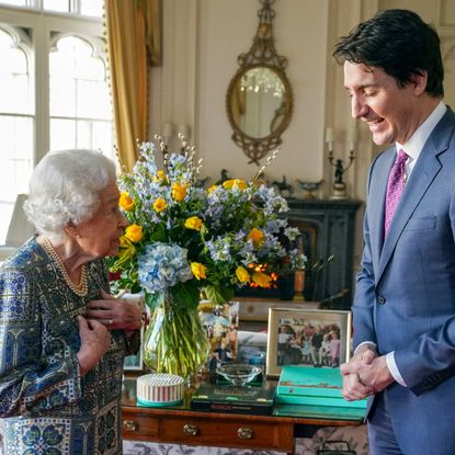 Britain's Queen Elizabeth II (L) speaks with Canadian Prime Minister Justin Trudeau during an audience at the Windsor Castle, Berkshire, on March 7, 2022.