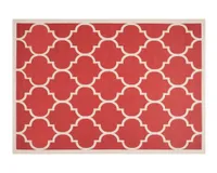 A red and beige patterned outdoor rug