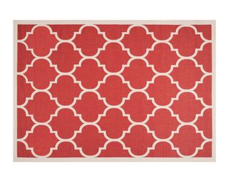 A red and beige patterned outdoor rug