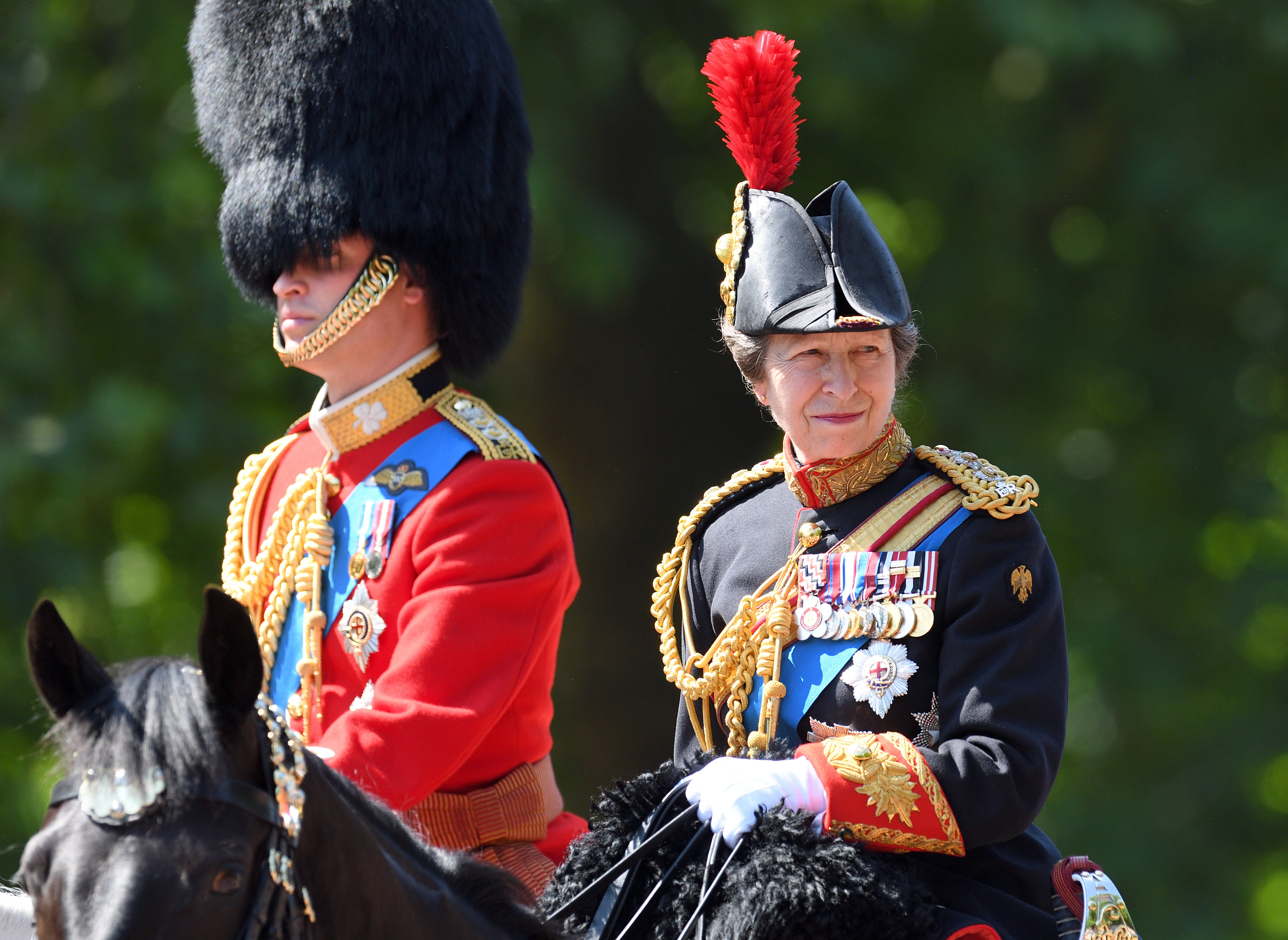 Prince William riding a horse next to Princess Anne