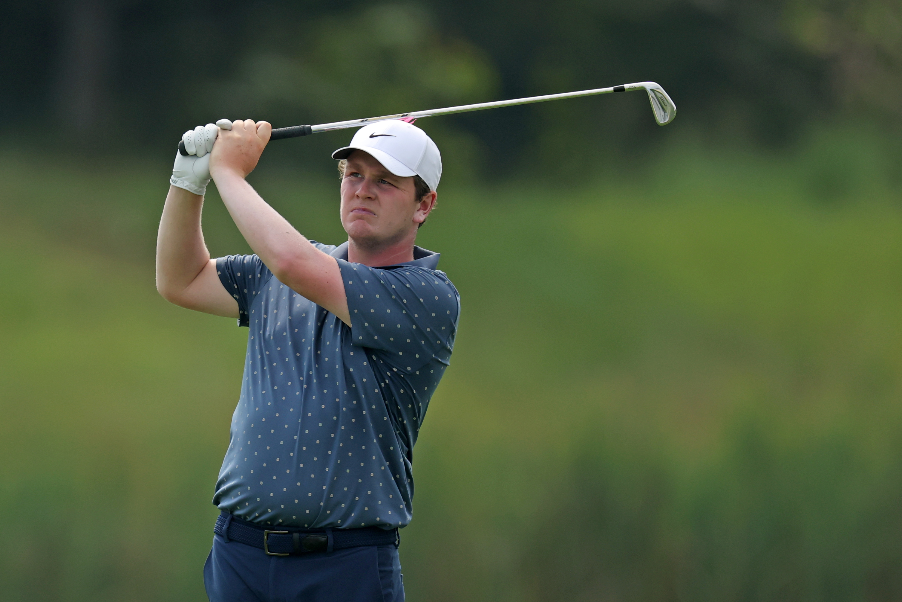 Robert MacIntyre hits an iron shot into the green