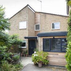 brick wall with window and plant with shrubs