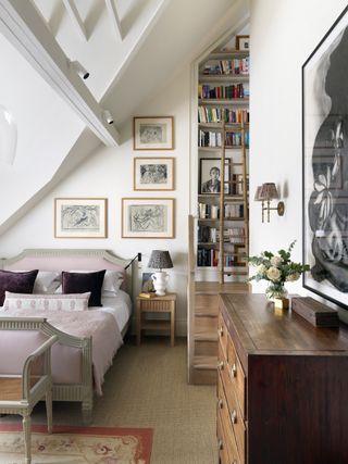 small master bedroom with built in shelving and artwork