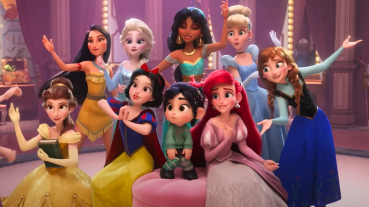 From left to right: Belle, Pocahontas, Elsa, Snow White, Jasmine, Vanellope von Schweetz, Ariel, Cinderella and Elsa standing together and doing princess poses. 
