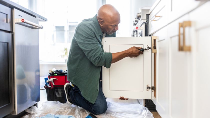 Man repairing kitchen door