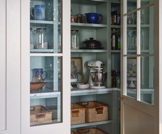 A small pantry painted a soothing blue