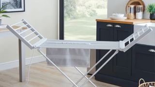 Dunelm heated winged airer in the middle of a kitchen