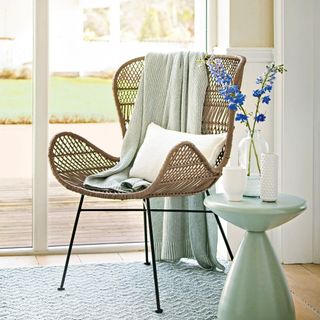 decking with erica rattan chair cushion and side table with flower vase