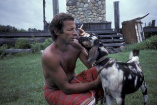 Shirtless man with a goat