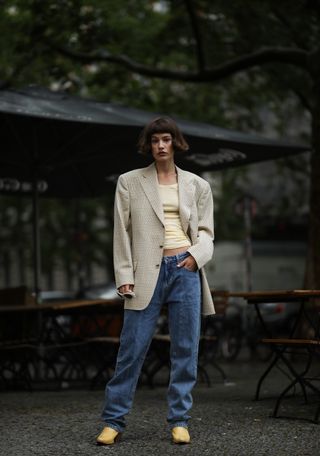 woman wearing oversized blazer, T-shirt, jeans, and cowboy boots
