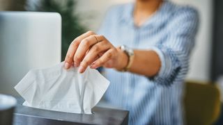 woman taking tissue out of tissue box