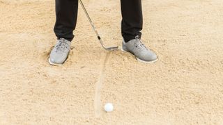 PGA pro Nick Drane in a bunker at Woburn after drawing a line in the sand with his golf club