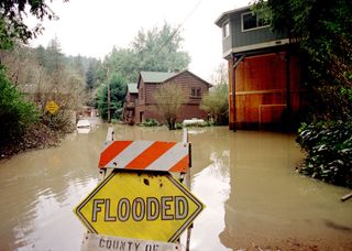 Flooded homes along the Russian River in California. NOAA scientists and colleagues are installing the first of four permanent "atmospheric river observatories" in California this month, to better monitor and predict the impacts of powerful winter storms associated with atmospheric rivers.