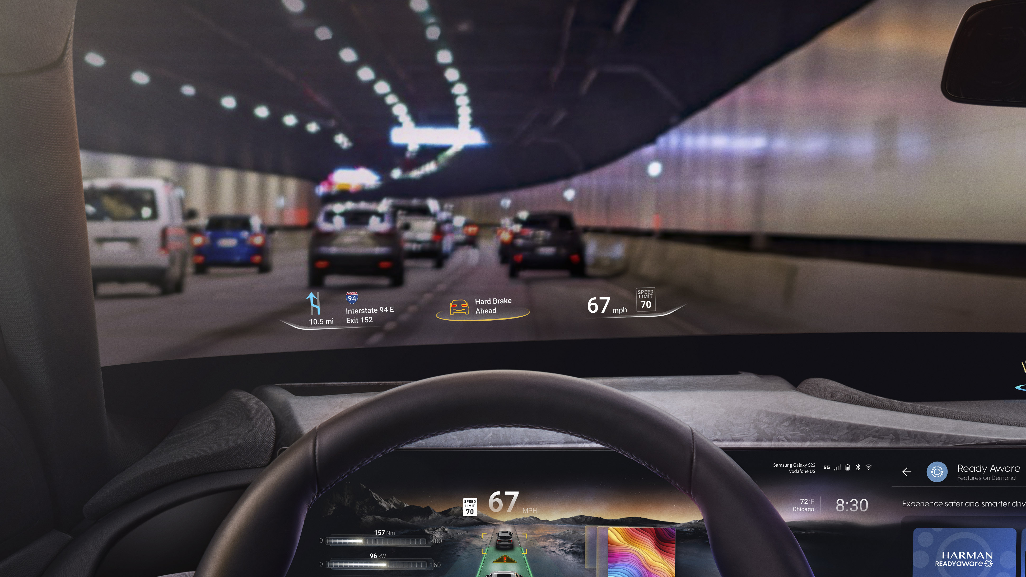 An in-car view showing a steering wheel and Harman's Ready Aware tech on the windshield