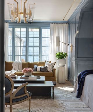 large bedroom with traditional decor, light blue walls and neutral colors throughout