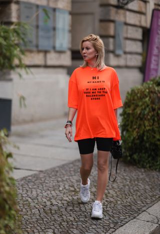 woman wearing t-shirt, biker shorts, and sneakers