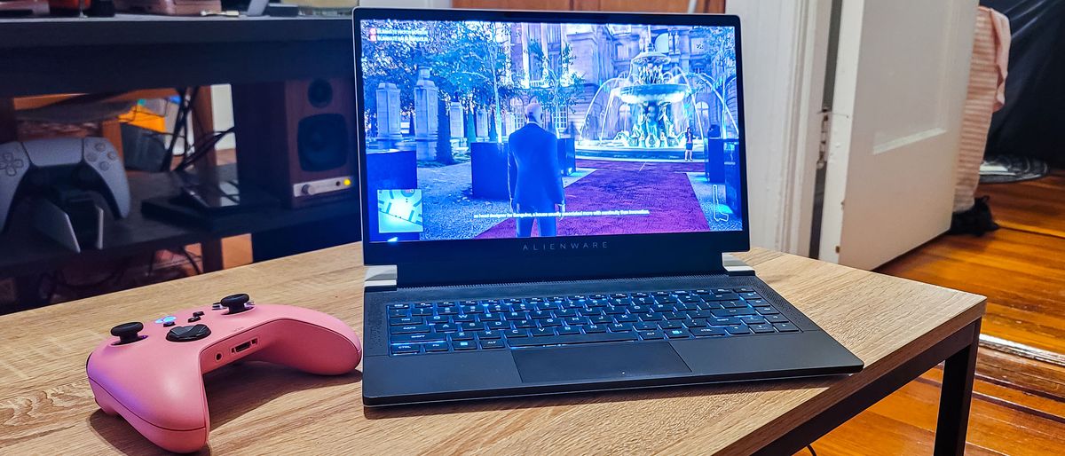 Alienware X14 on a table, playing Hitman III