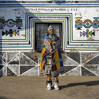Esther Mahlangu in front of mural