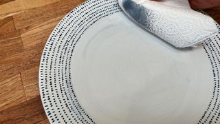 Rubbing a scratched plate to remove marks