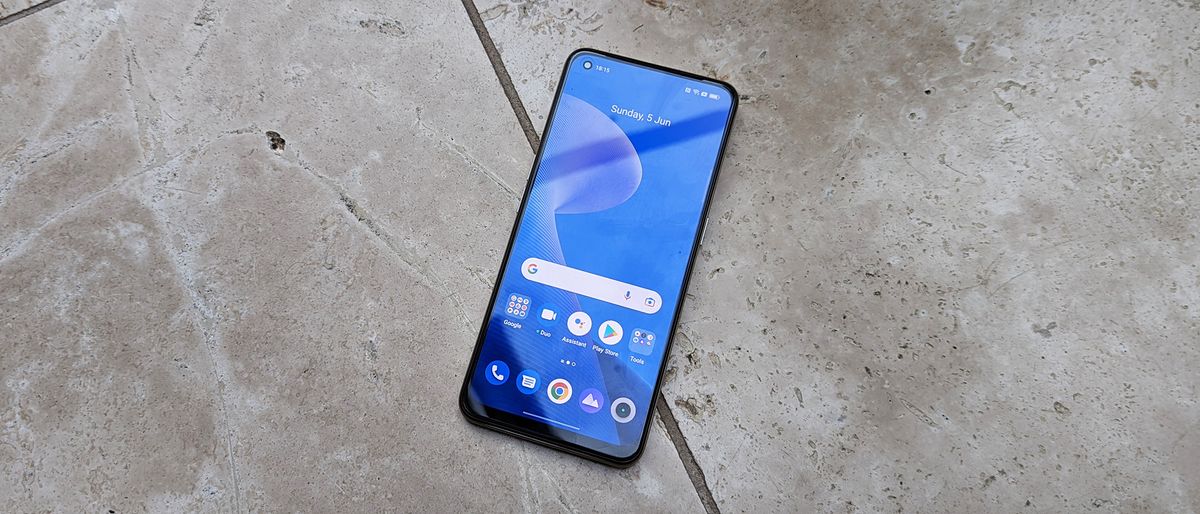 The Realme 9 lying face up on a tiled floor