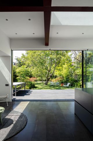 View from inside modernist London extension looking out to garden