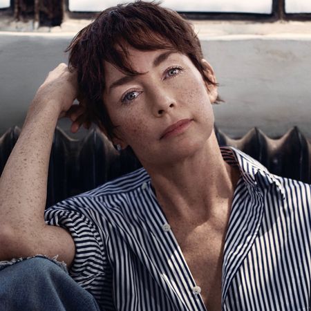 A portrait of actress Julianne Nicholson, sitting in front of a window and a radiator.
