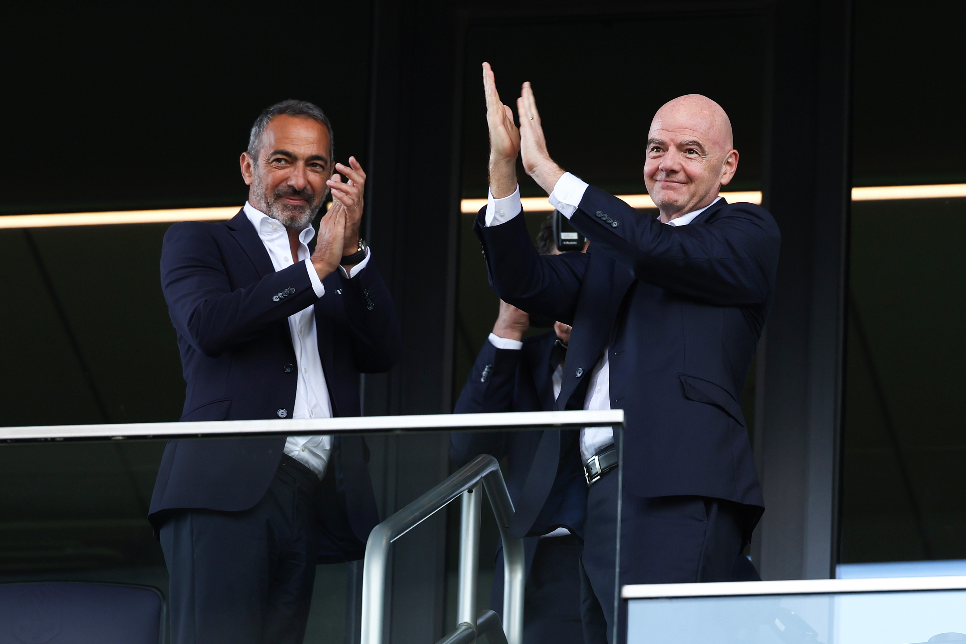 NASHVILLE, TENNESSEE - JUNE 24: Youri Djorkaeff and Gianni Infantino, President of FIFA, interact with the fans from the stands during the FIFA Club World Cup 2025 group C match between Auckland City FC and CA Boca Juniors at GEODIS Park on June 24, 2025 in Nashville, Tennessee. (Photo by Donald Page - FIFA/FIFA via Getty Images)
