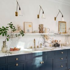 kitchen area with marble worktop and indigo colour cabinet