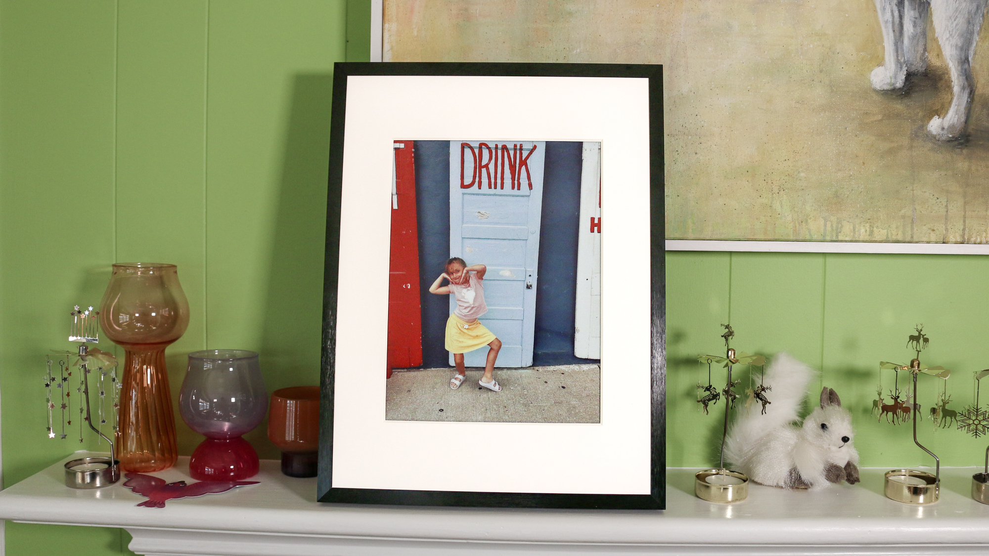 A Switchbot photo frame on a mantlepiece