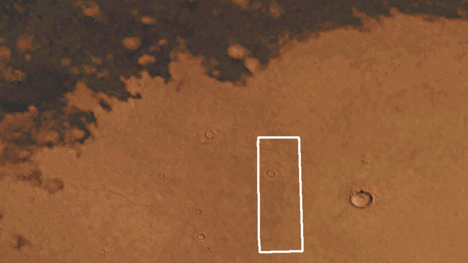 Looped comparison of two photos showing how far a dark patch on Mars has moved over the last 50 years