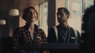 Jessie Buckley laughs as Riz Ahmed looks at her in Fingernails.