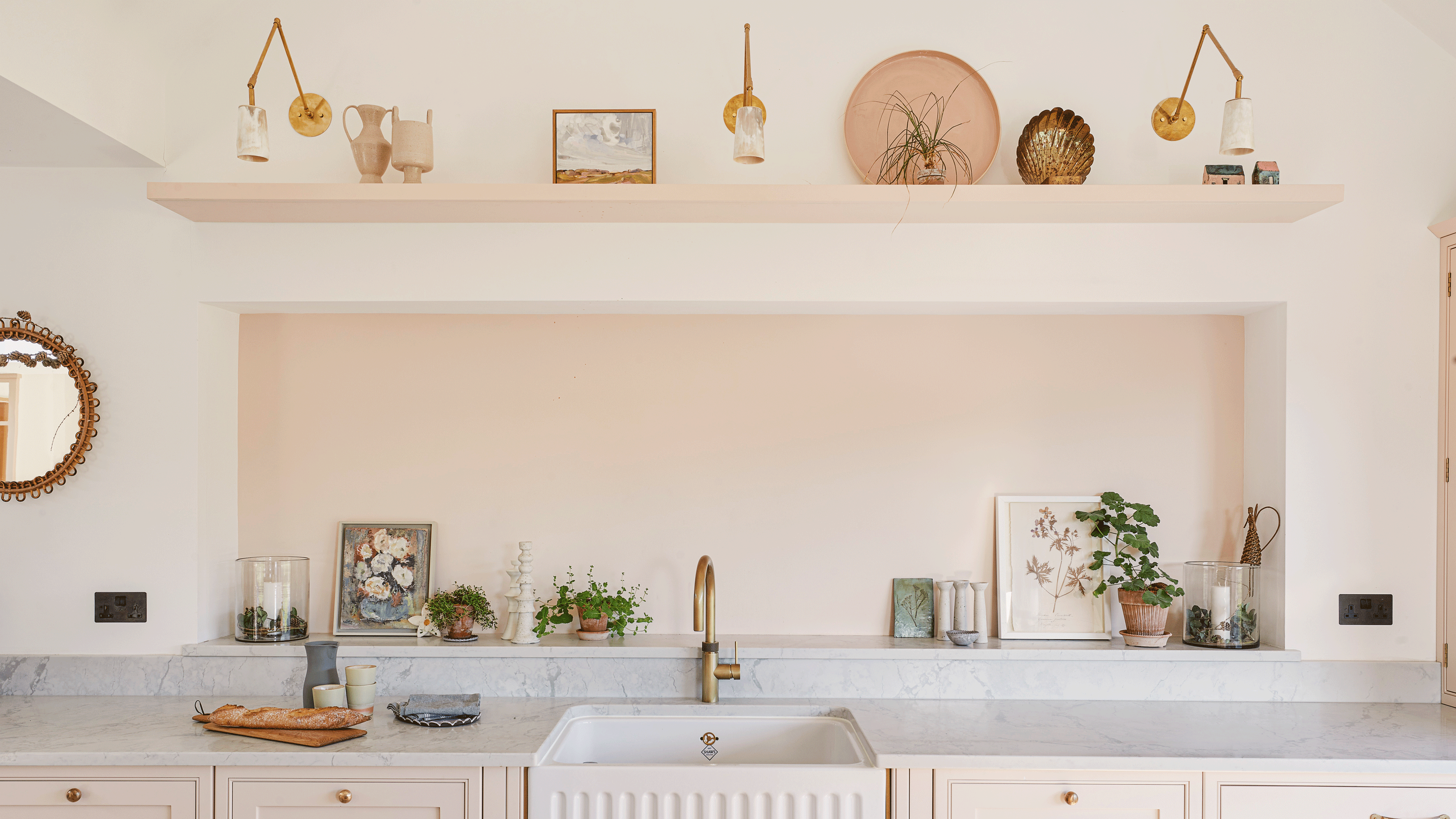 Pink kitchen with plaster pink walls, marble worktop and butler sink