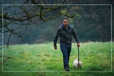 Ukweli Roach as Jack Caffey from Wolf walking a dog in a field