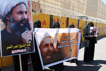 Yemeni demonstrators protest the 2014 death sentence of Sheikh Nimr al-Nimr.