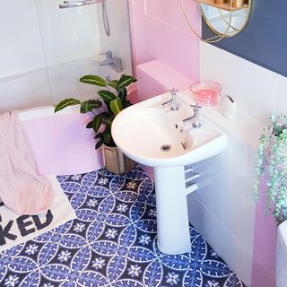bathroom with white wash basin and taps and pink wall