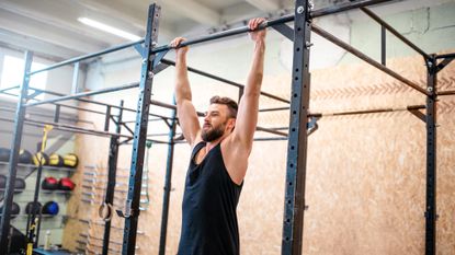 Man holding onto a bar