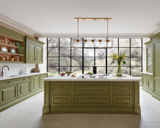 Traditional kitchen with green cabinets and large island
