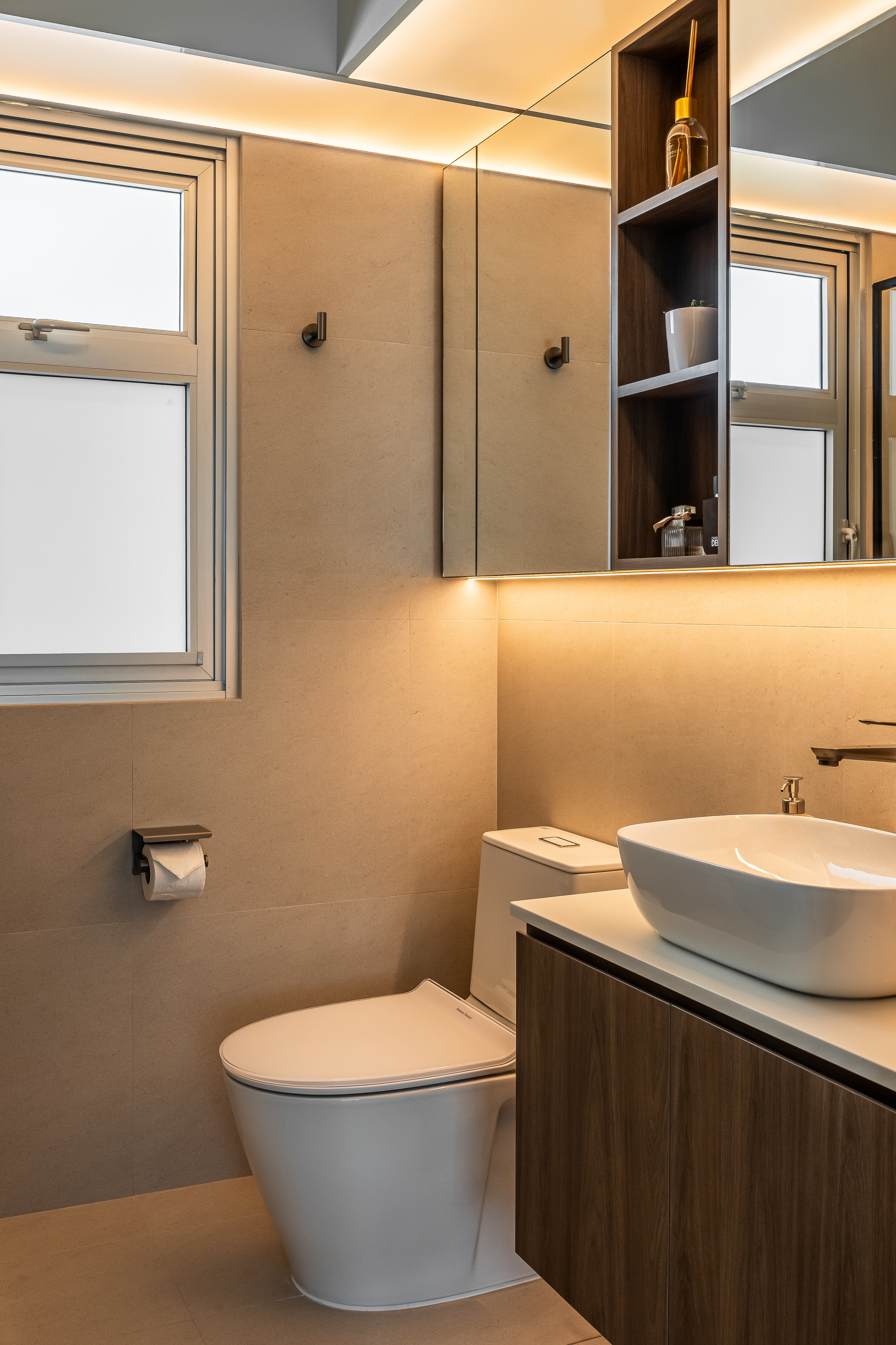 A bathroom with LED lights hidden under the cabinets and in the ceiling