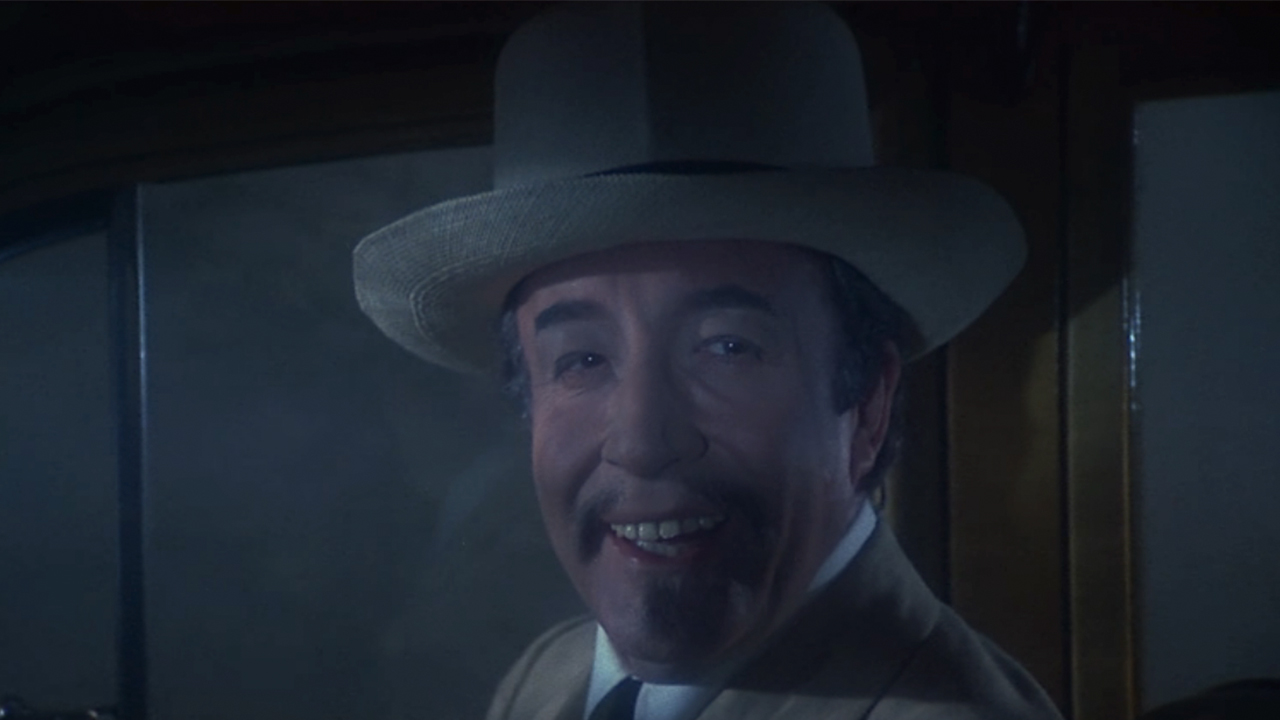 Peter Sellers as a Chinese man, wearing a yellow fedora in Murder by Death